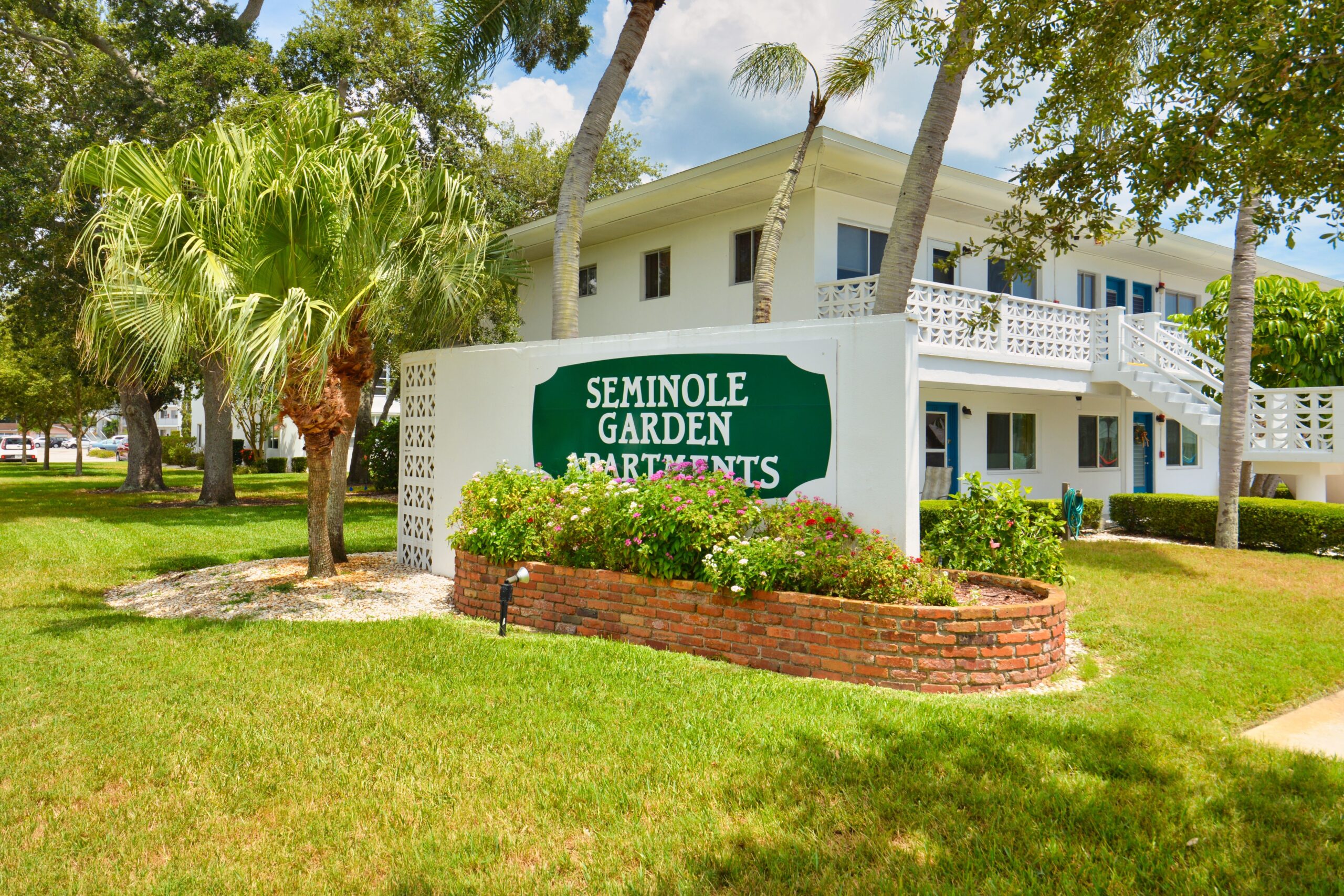 Seminole Gardens Apartments entrance sign and courtyard