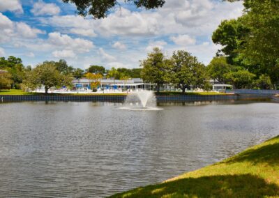 Fountain lake at Seminole Gardens with pool and clubhouse in the background