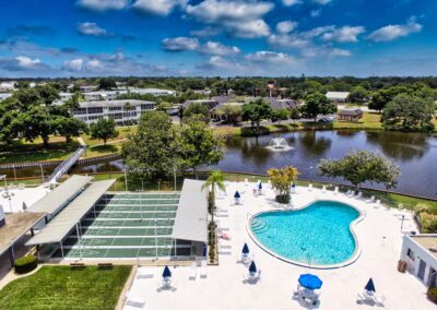 Aerial view of Seminole Gardens pool, shuffleboard courts, and lake
